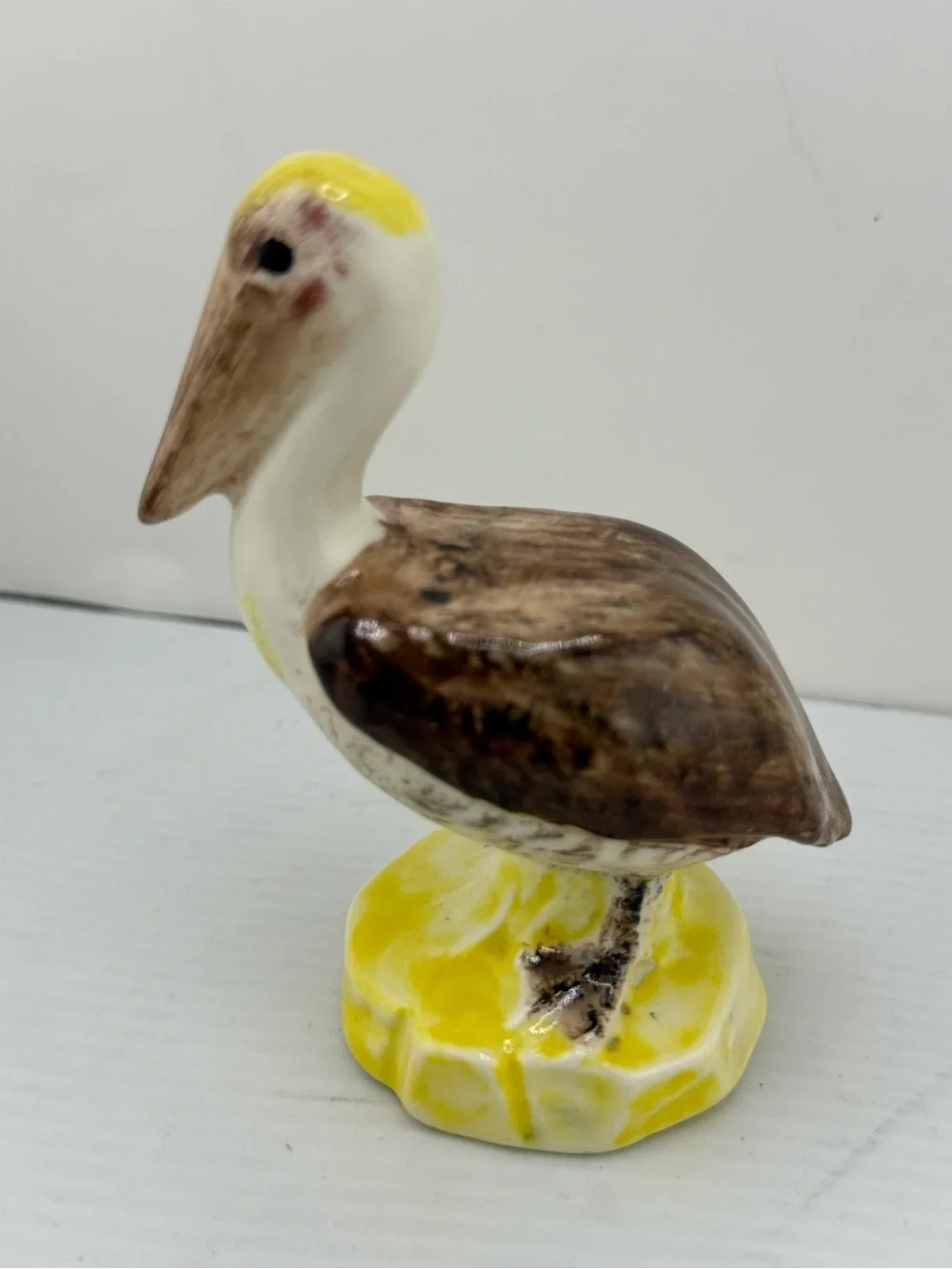 Vintage ceramic brown pelican figurine,